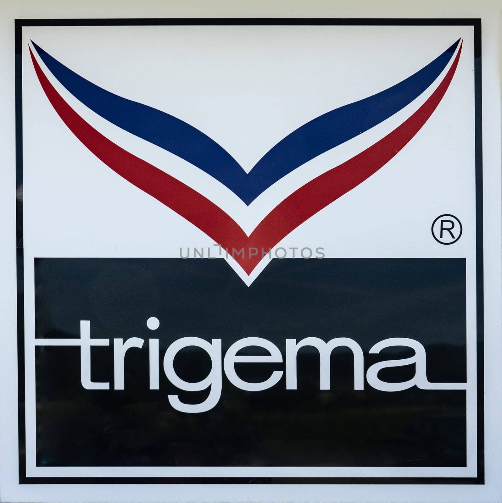KIRCHHEIM, GERMANY -2019-07-10: TRIGEMA Logo Advertisement. TRIGEMA was established in 1919 and is Germany’s largest manufacturer of sportswear and casual fashion.