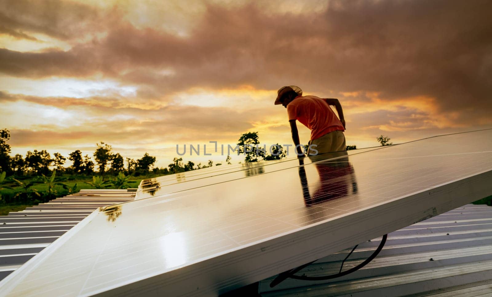 Man checking solar panel on roof for safety. Solar panel or photovoltaic module maintenance. Sustainable resource and renewable energy. Solar power for green energy. Sustainble lifestyle. Clean power
