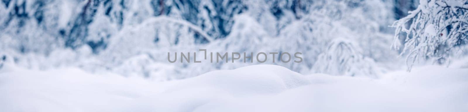 Snowy background with closeup view of the wavy snowdrifts. Concept of the wallpaper, background and backdrop.