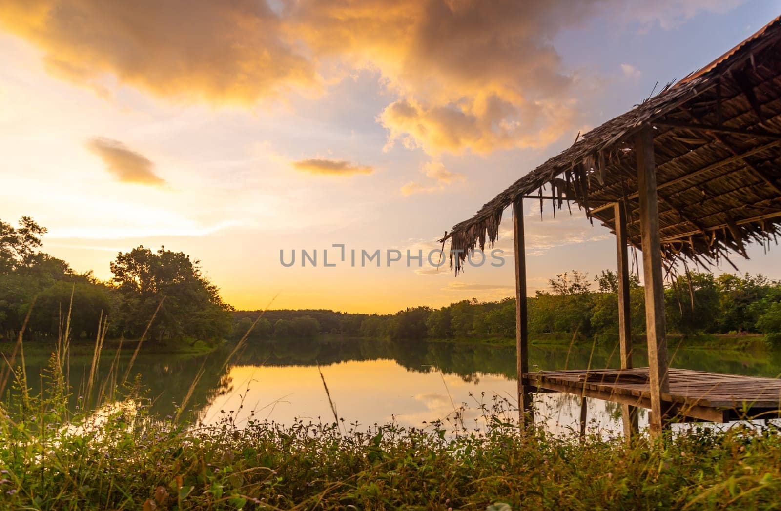 View of Colorful dramatic sky sunset or sunrise with clouds background on Water River in Forest, Sky with cloud in nature and travel concept.