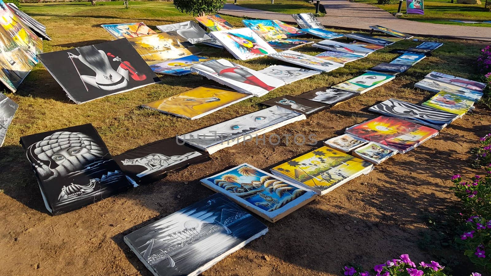 Egypt, Sharm El Sheikh - June 20, 2019: paintings for sale on the street in a park in the Amway Hotel. Flea market and street gallery of art and creativity