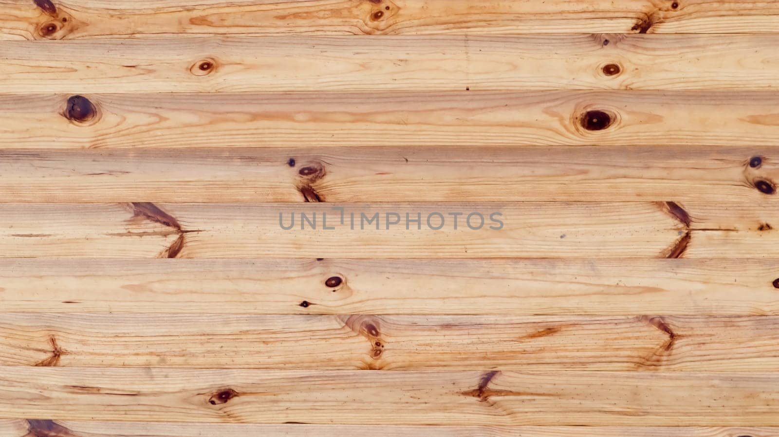 Brown rustic wood texture background. Natural background pattern from a log wall. Facade of a log house, copy space. A board with lots of horizontal wooden logs