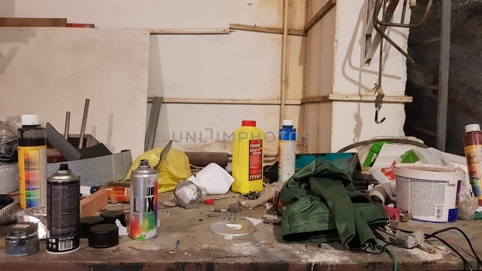 Ukraine, Kiev - May 09, 2020: Work tools on the board and in the workshop. Workshop scene. A lot of old tools on a dirty desktop. The concept of carpentry and painting