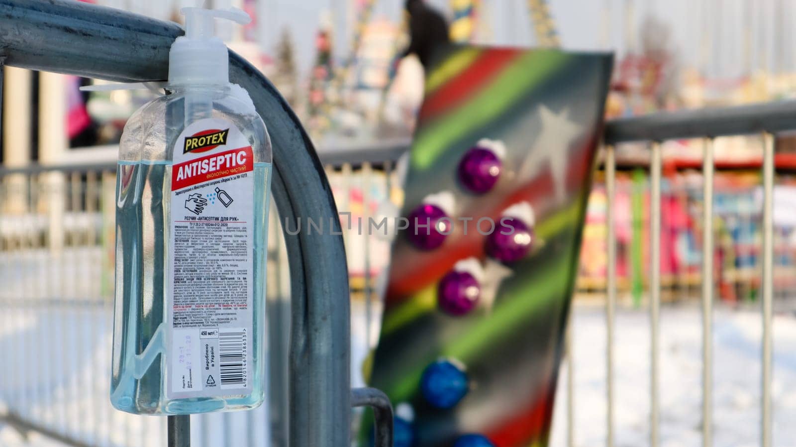 Disinfectant near the ticket booth in an amusement park. Close-up of a disinfectant with a label that has English text for visitors to the amusement park. Ukraine, Kiev - January 14, 2021
