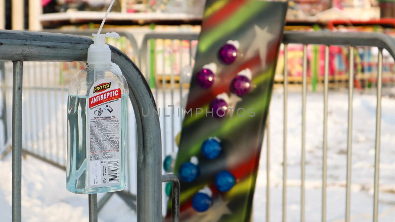 Disinfectant near the ticket booth in an amusement park. Close-up of a disinfectant with a label that has English text for visitors to the amusement park. Ukraine, Kiev - January 14, 2021