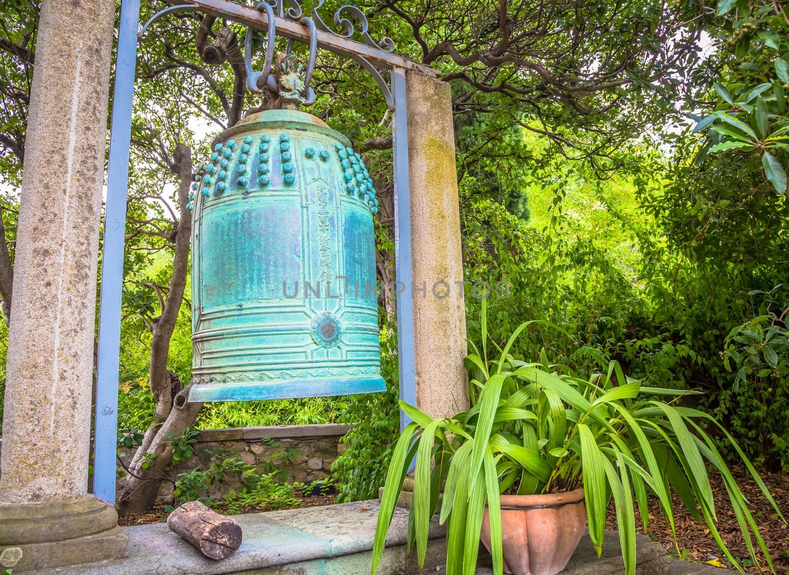 VENTIMIGLIA, ITALY - CIRCA AUGUST 2020: old Japanese bell located in Hambury Gardens and finely crafted in bronze. It seems to come from a Buddhist shrine destroyed by a fire in central Japan.