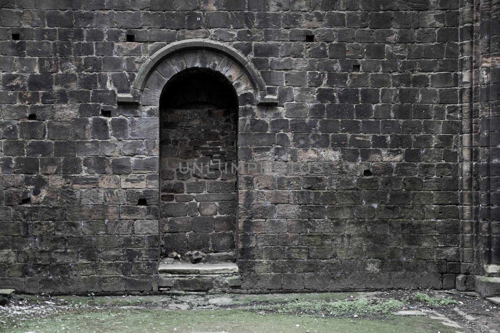 A bricked up doorway in an old gothic building