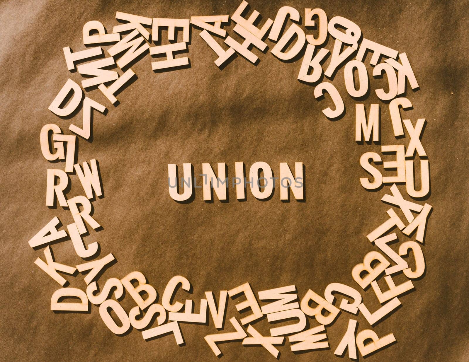 Union Word In Wooden Cube Alphabet Letters Top View On A rustic paper Background.