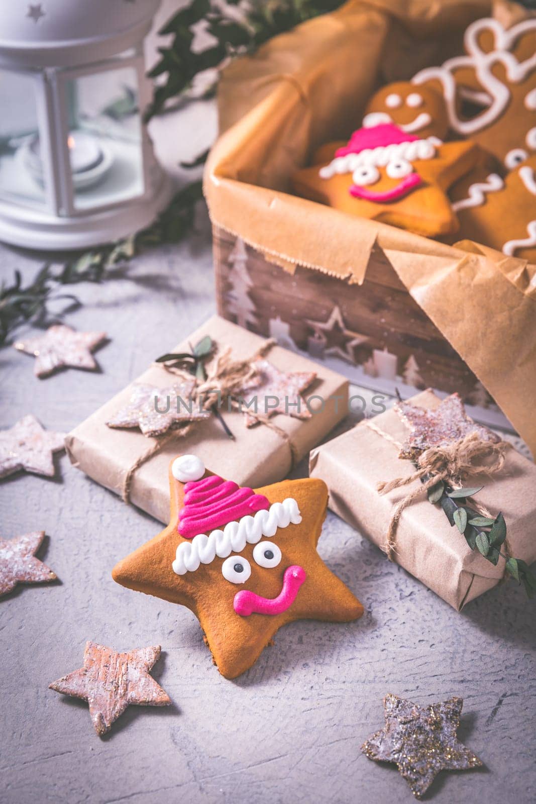 Gingerbread cookies for Christmas in cookie box with stars and small presents