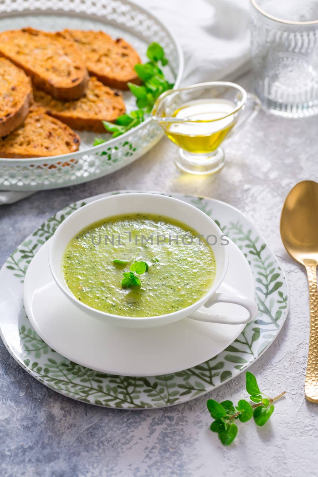 Homemade zucchini soup with tomato ciabatta bread and herbs