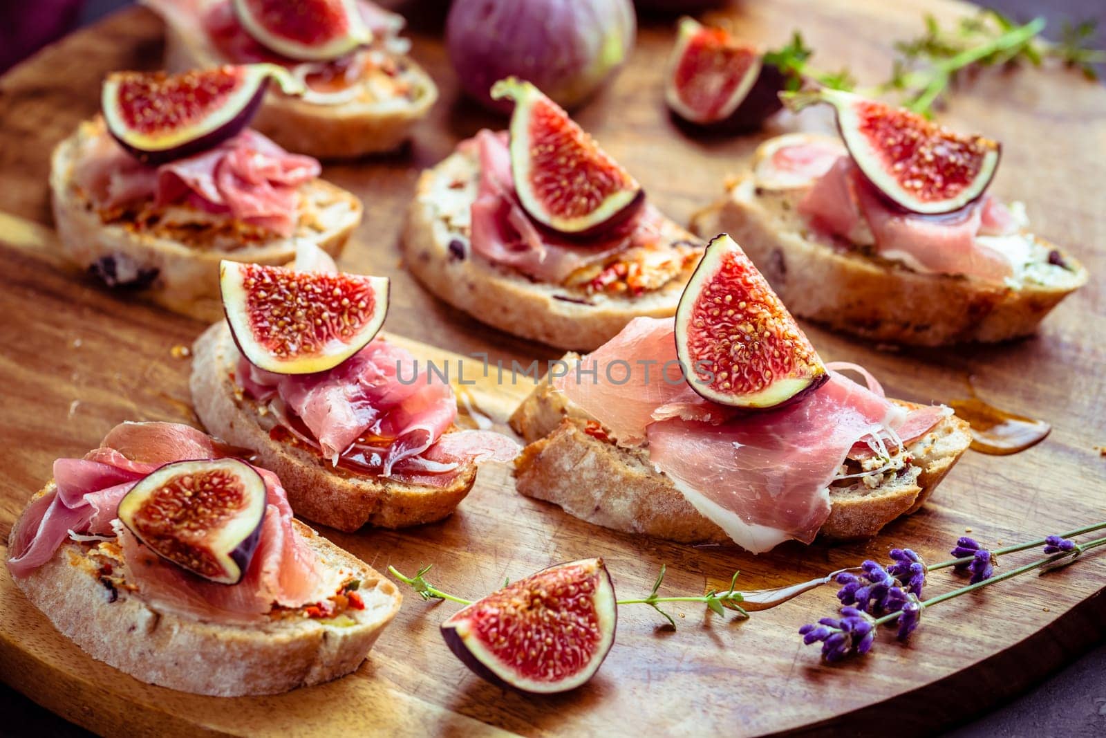 Small open sandwiches with ciabatta, proscuitto and fresh figs as appetizes