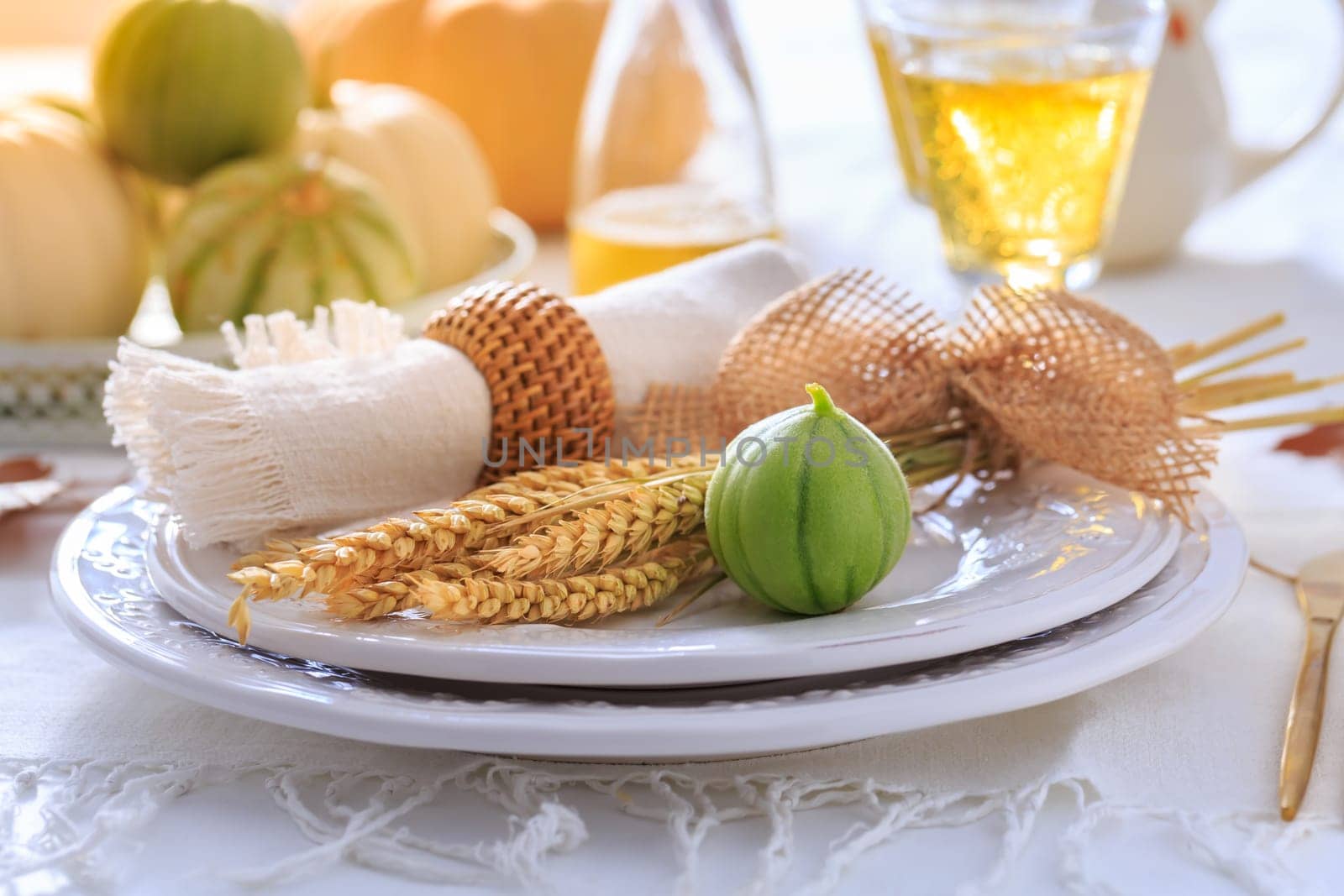 Place settings for Thanksgiving with pumpkins, ears and apple wine