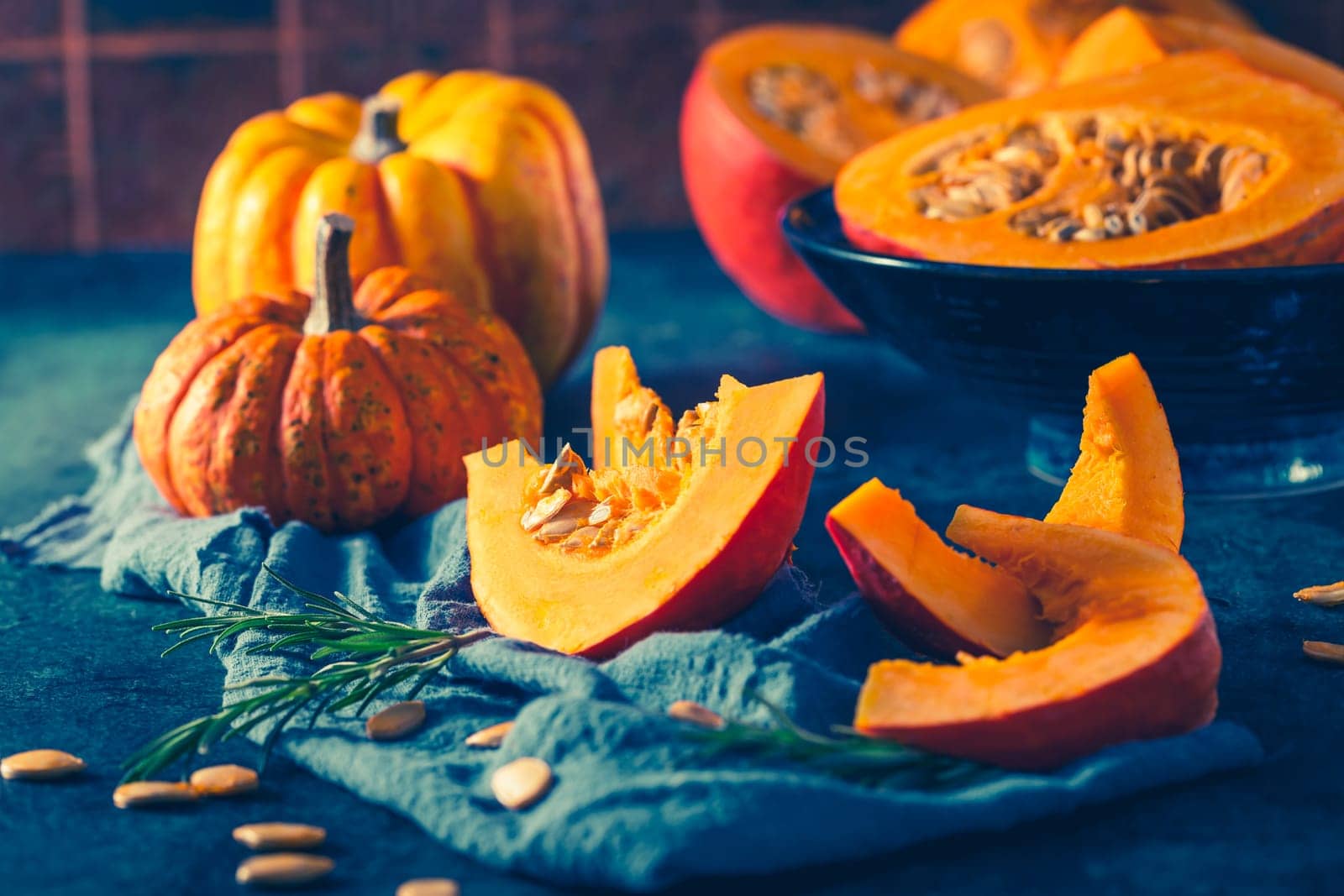 Organic pumpkin with seeds ready for cooking on blue background