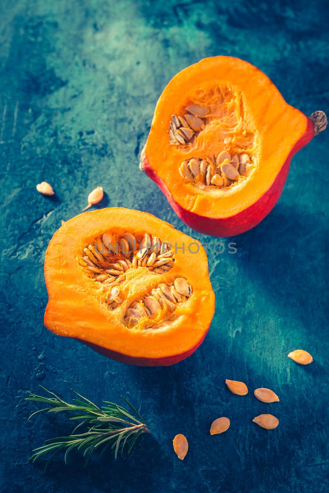 Organic pumpkin with seeds ready for cooking on blue background