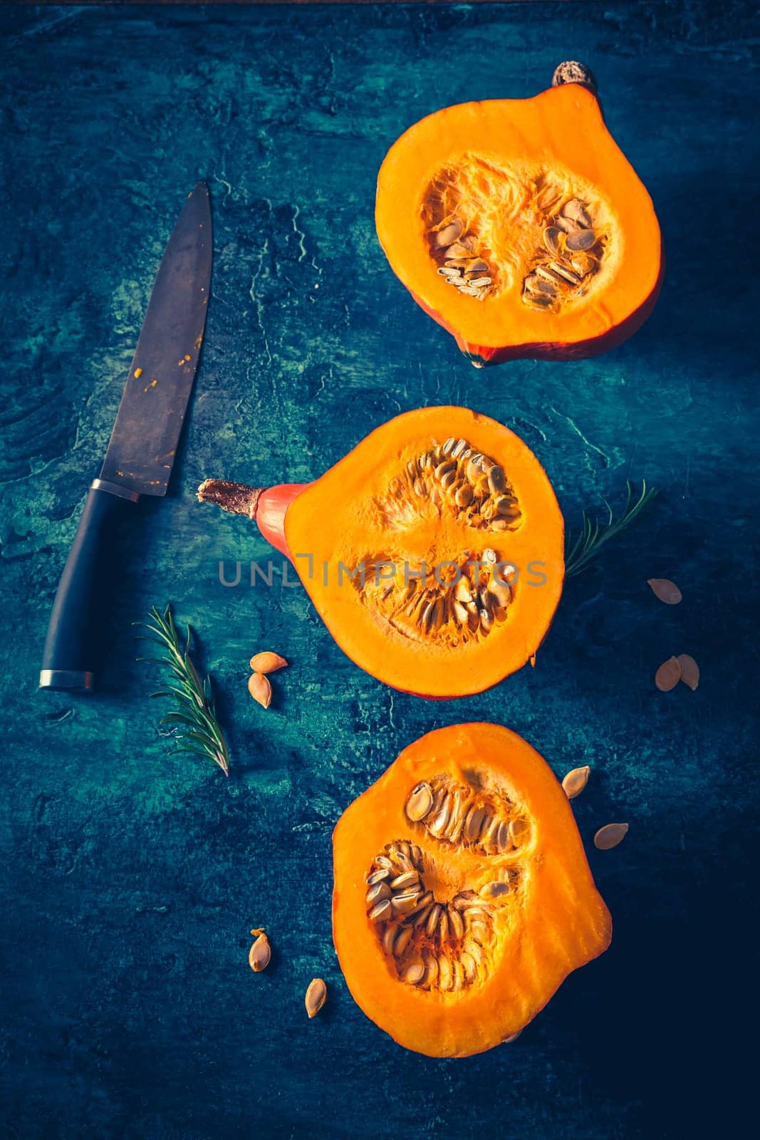 Organic pumpkin with seeds ready for cooking on blue background
