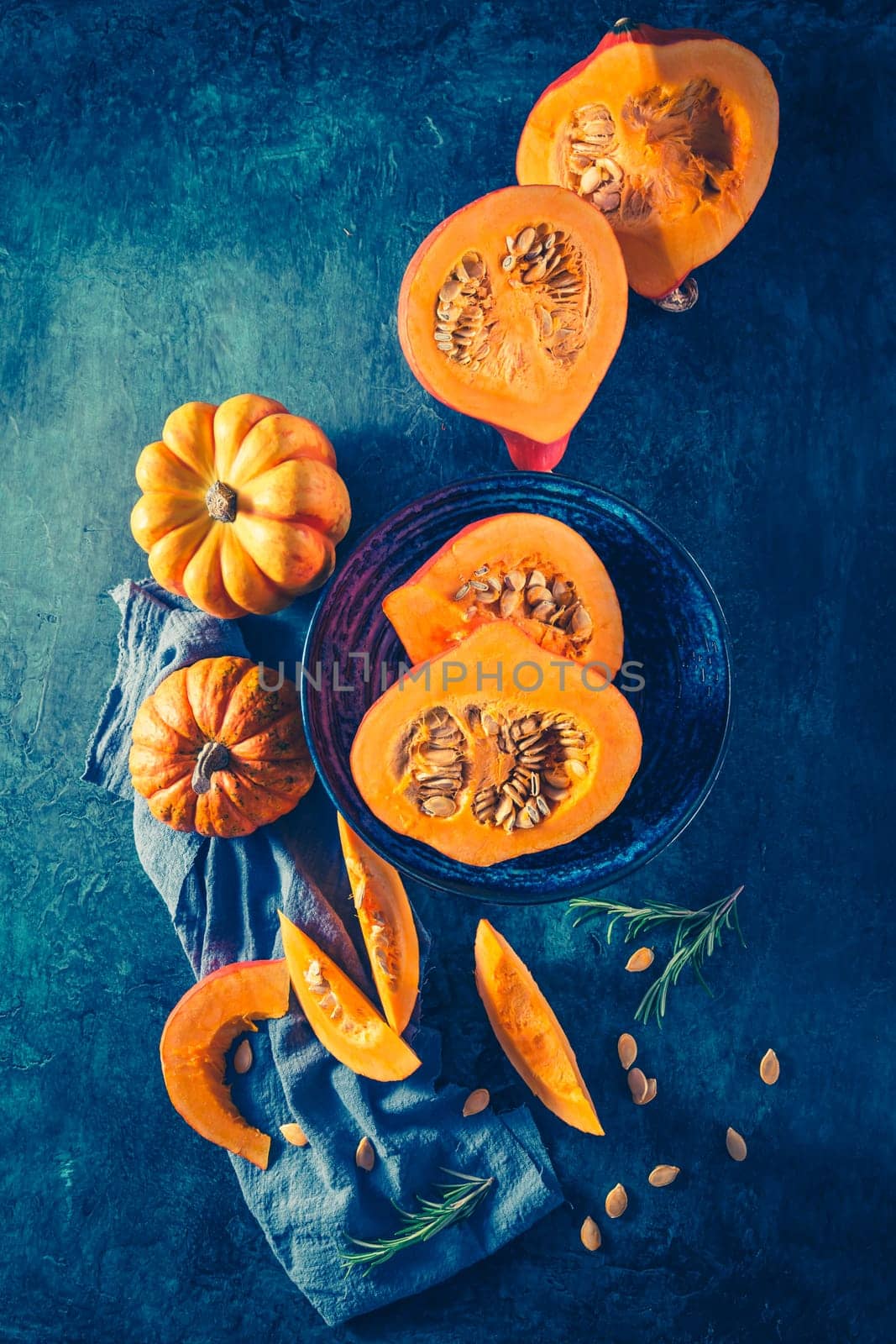 Organic pumpkin with seeds ready for cooking on blue background