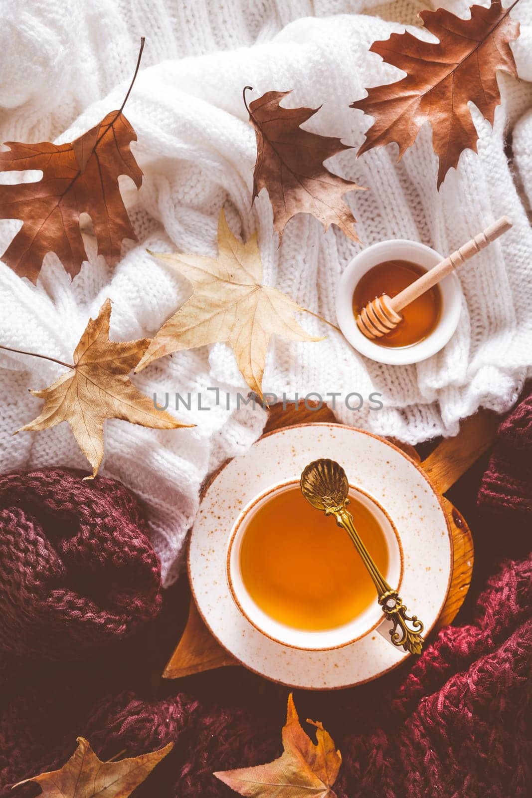 Hot tea with honey, warm sweaters and autumn leaves
