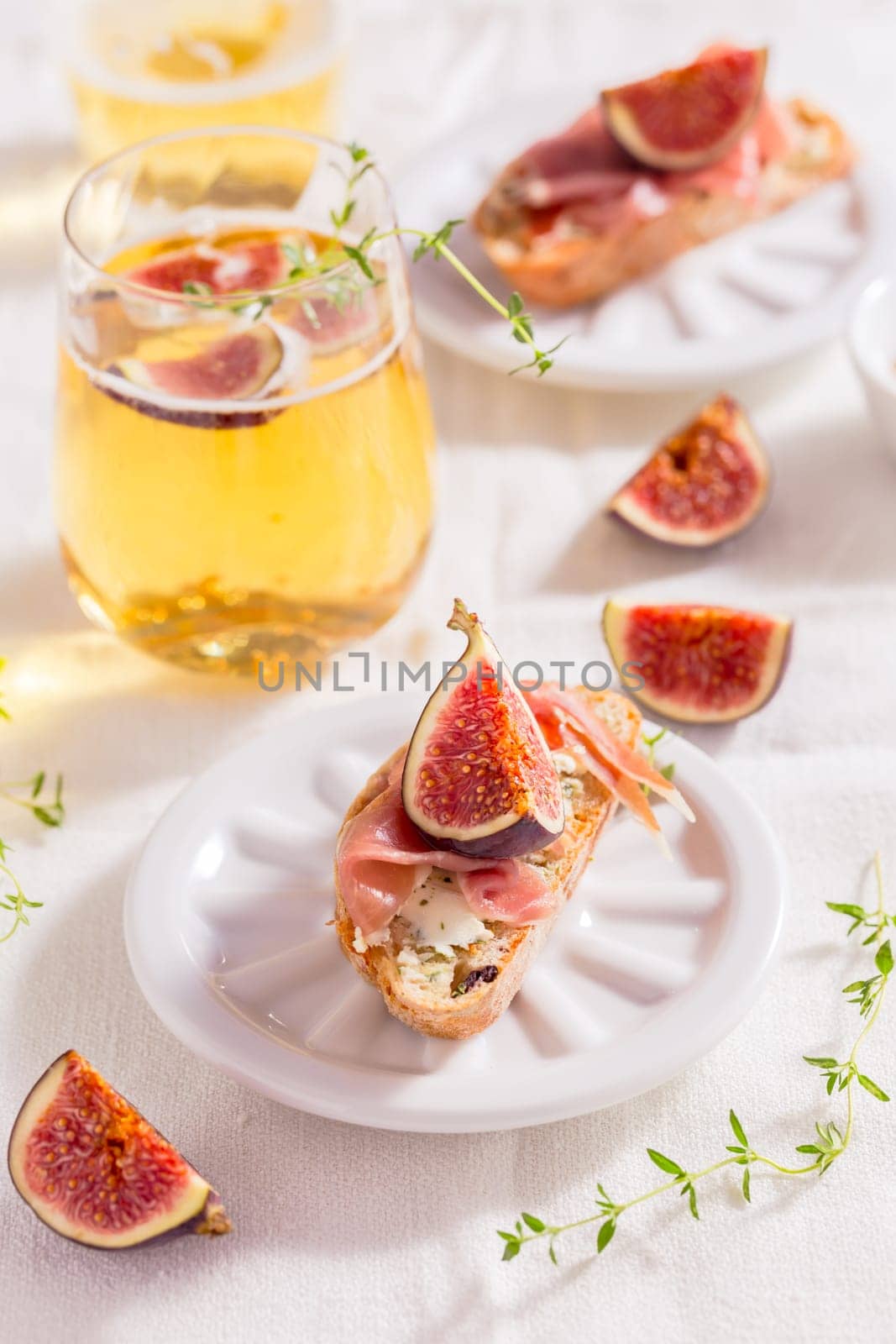 Small canape snack, crostini with ham, fig and apple wine, Italian antipasti