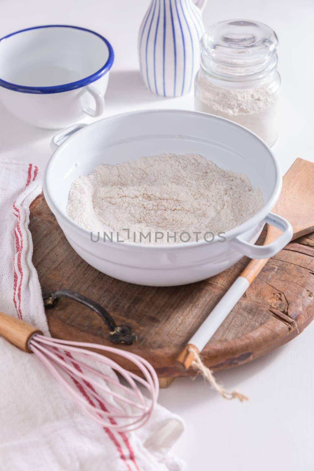 Flour and egg with baking ingredients and kitchen utensils