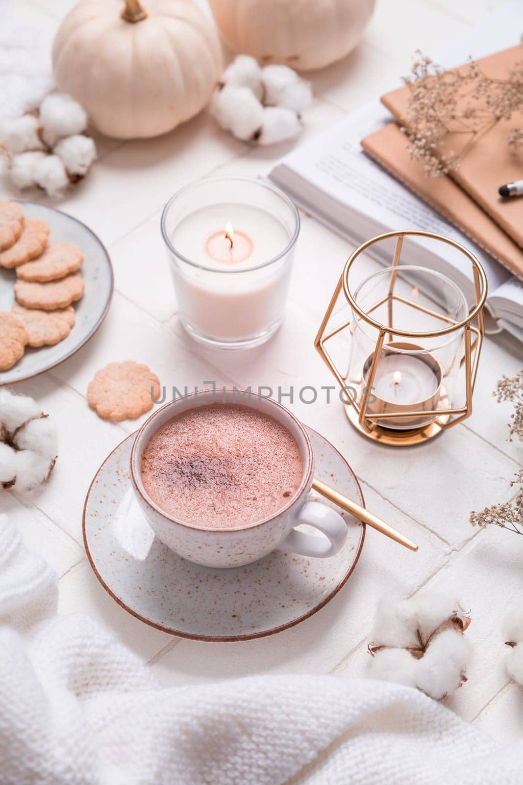 Autumn and winter still life with hot chocolate and cocoa, cookies, candles in white
