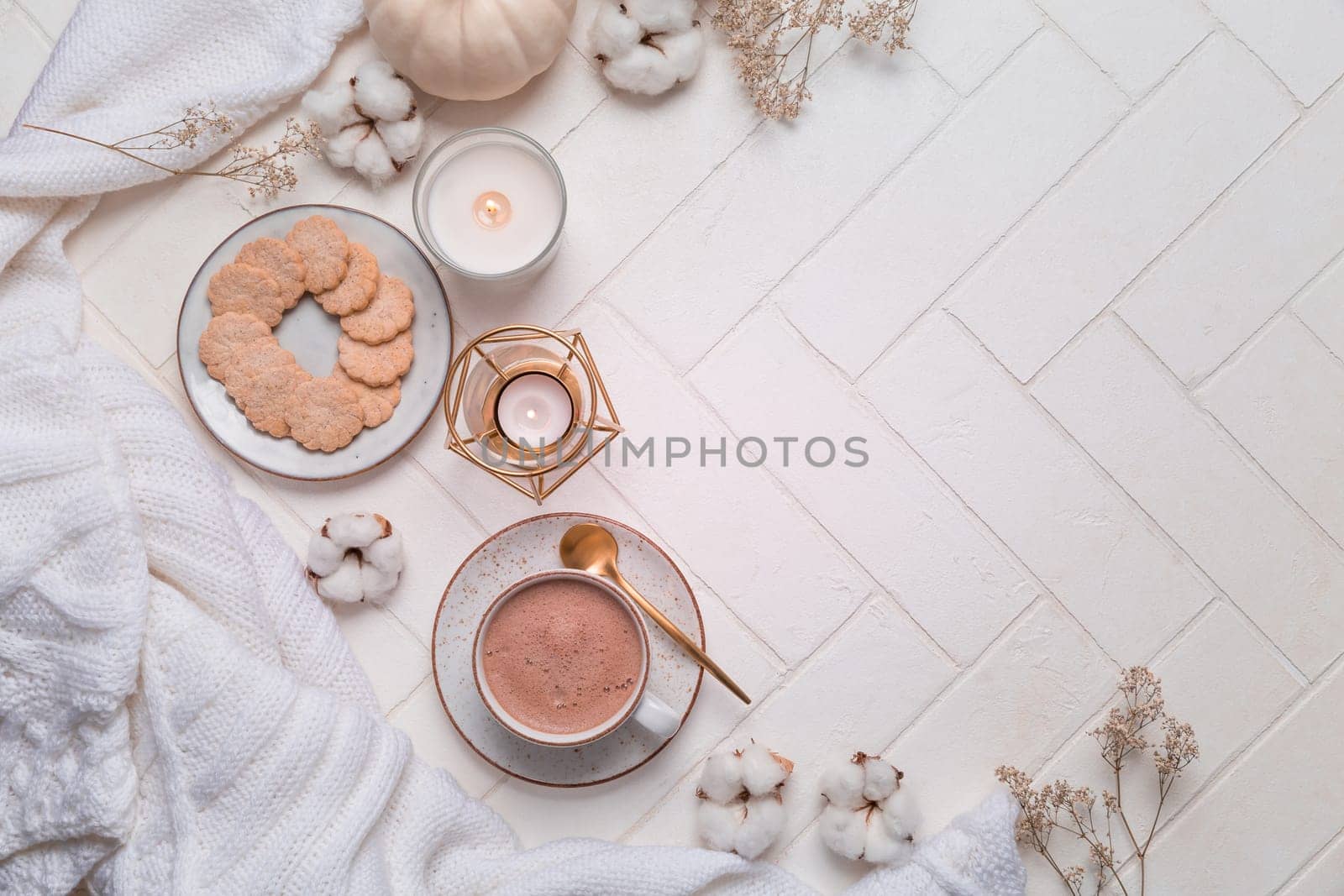 Autumn and winter still life with hot chocolate and cocoa, cookies, candles in white