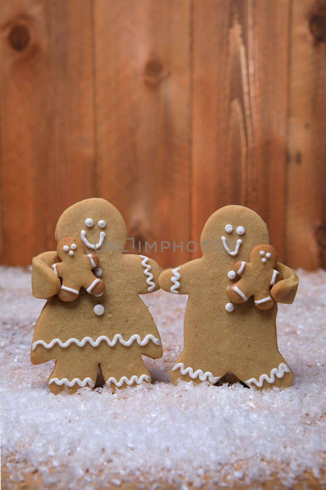 Gingerbread Family of 2 kids on Holiday Christmas Background