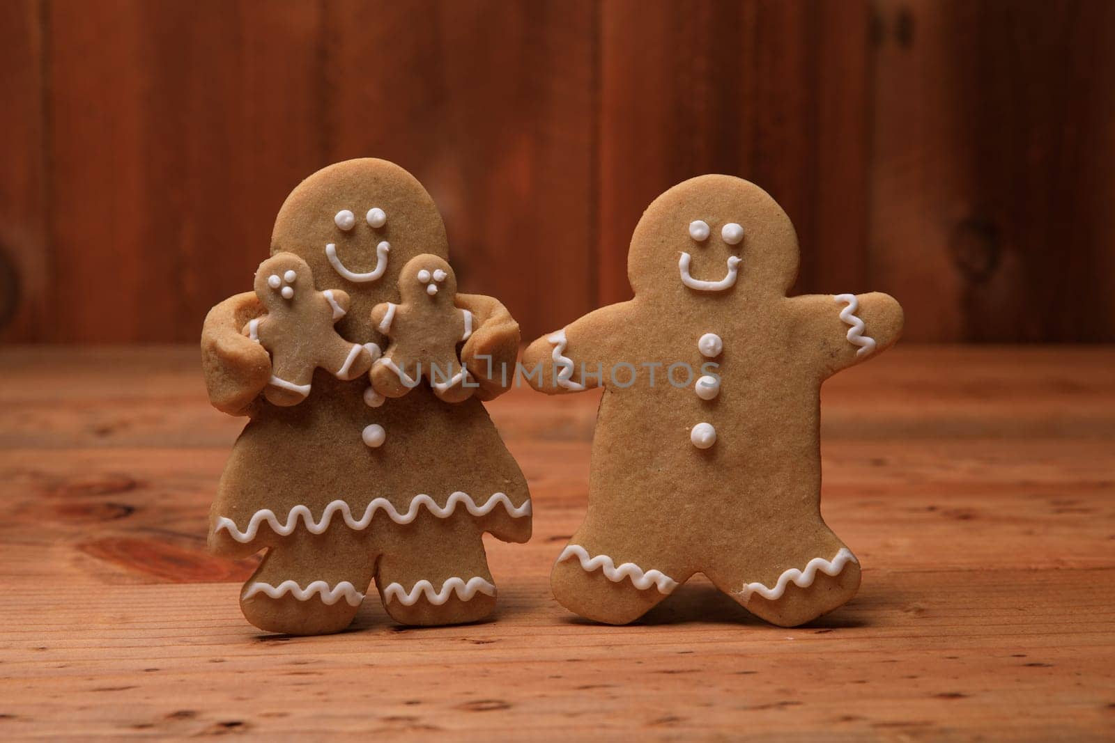 Gingerbread Family of 2 kids on Holiday Christmas Background