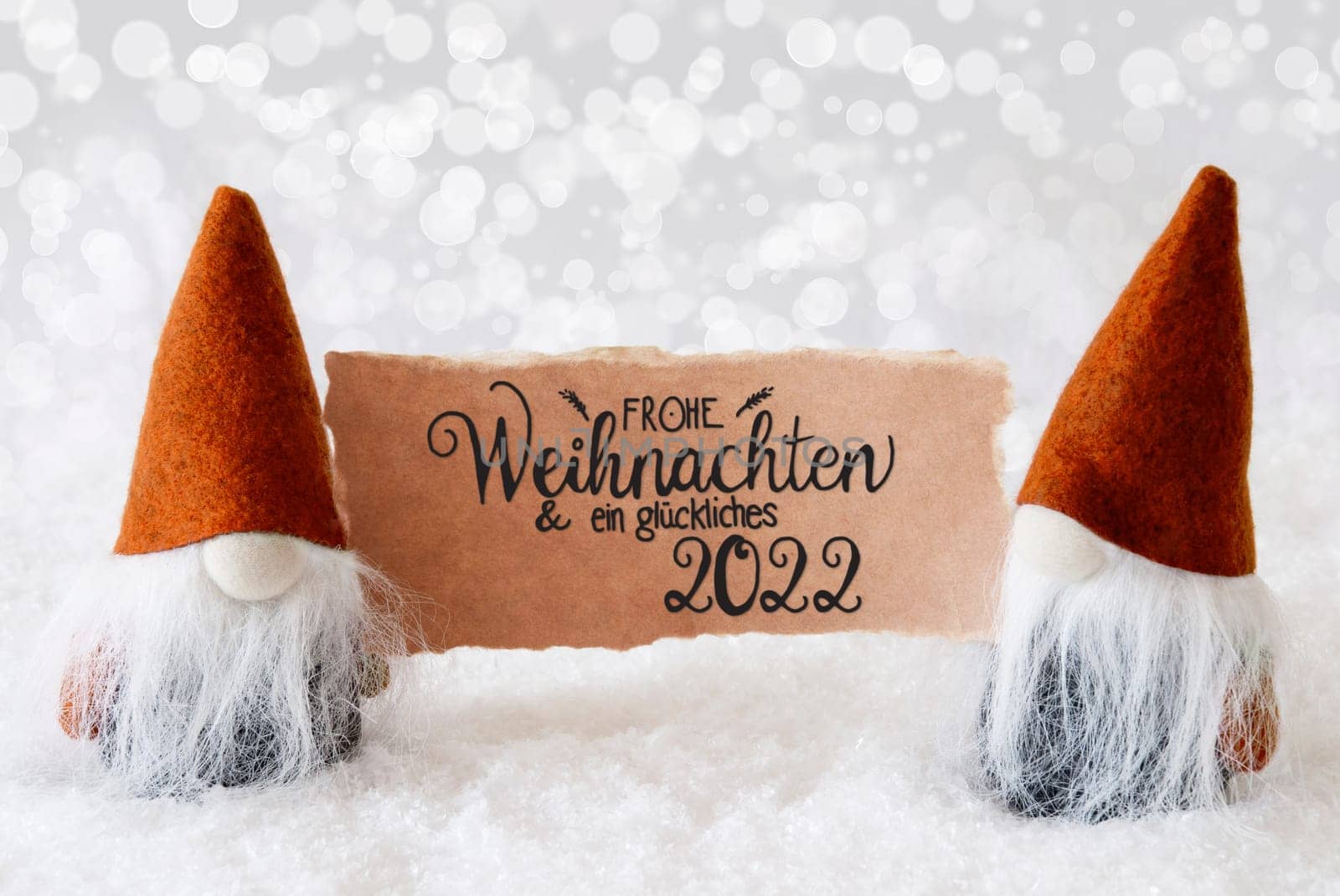 Sign With German Calligraphy Frohe Weihnachten Und Ein Glueckliches 2022 Means Merry Christmas And A Happy 2022. Santa Claus With Orange Hat. Snow With Gray Sparkling Background