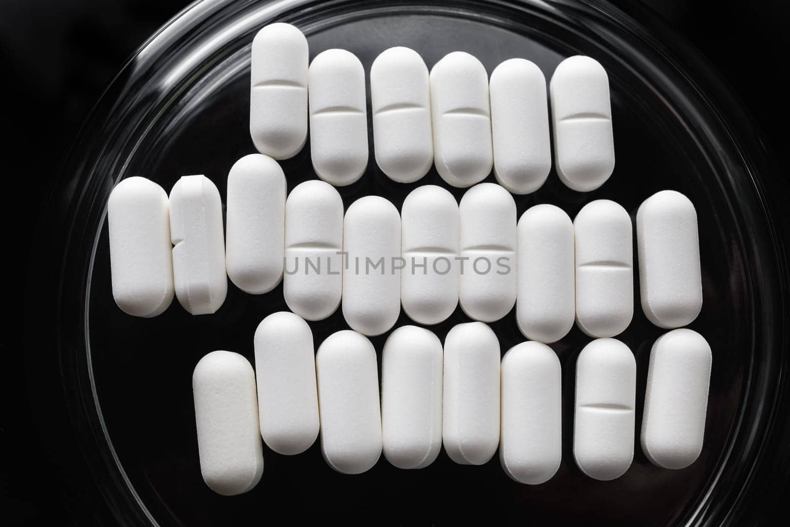 Many pills in glass saucer. Healthcare concept. Flat lay.