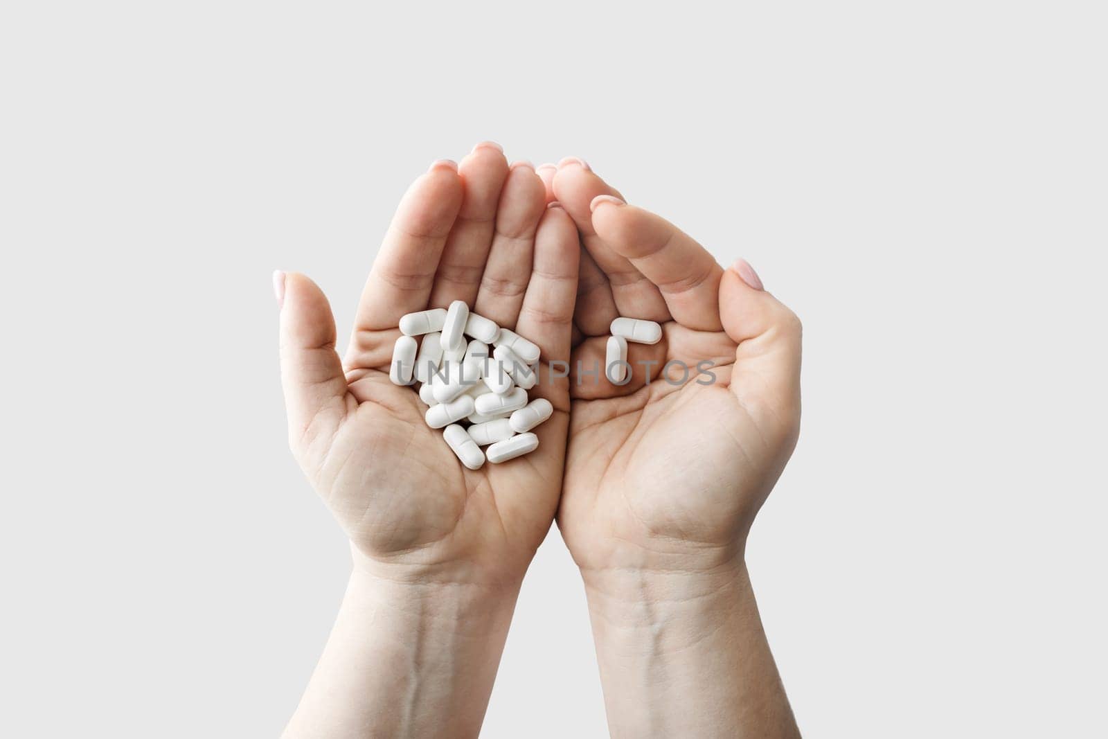 Many pills in female hands. Treatment healthcare concept.