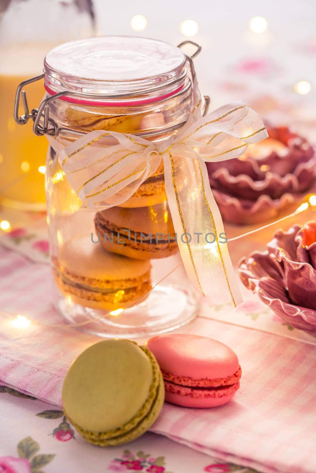 Sweet French macarons in cookie box with candles in vintage style
