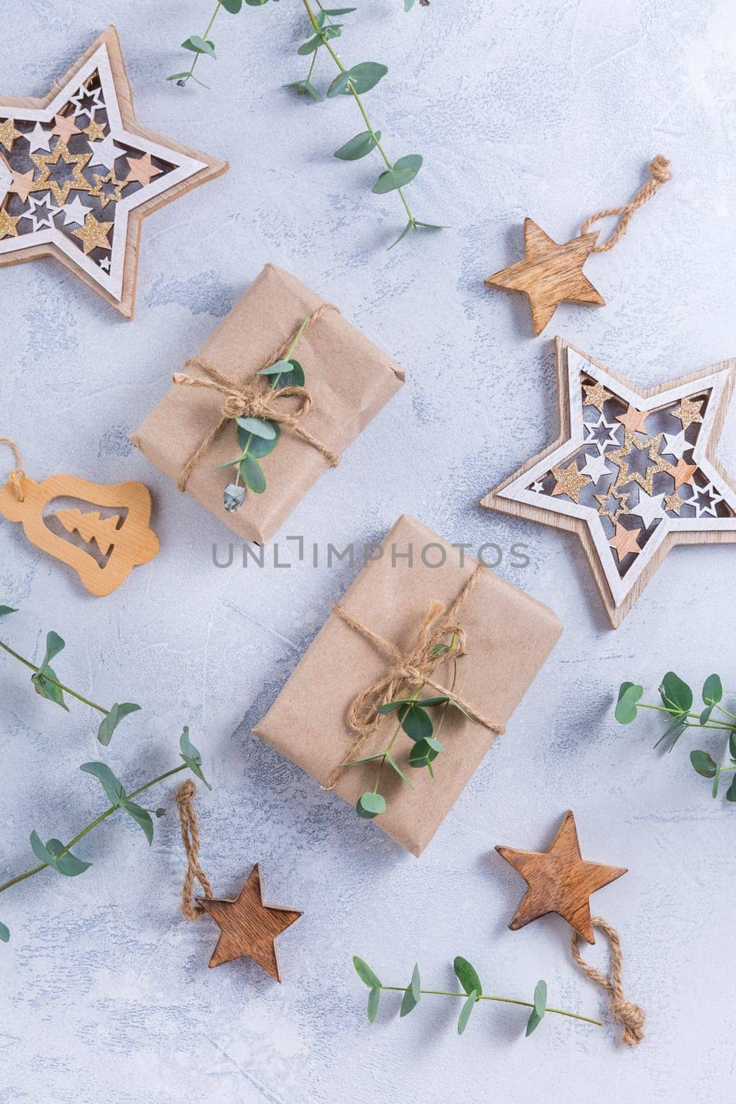 Holiday Christmas Gifts with Boxes, Coniferous, eucalyptus and ornaments on snowy background