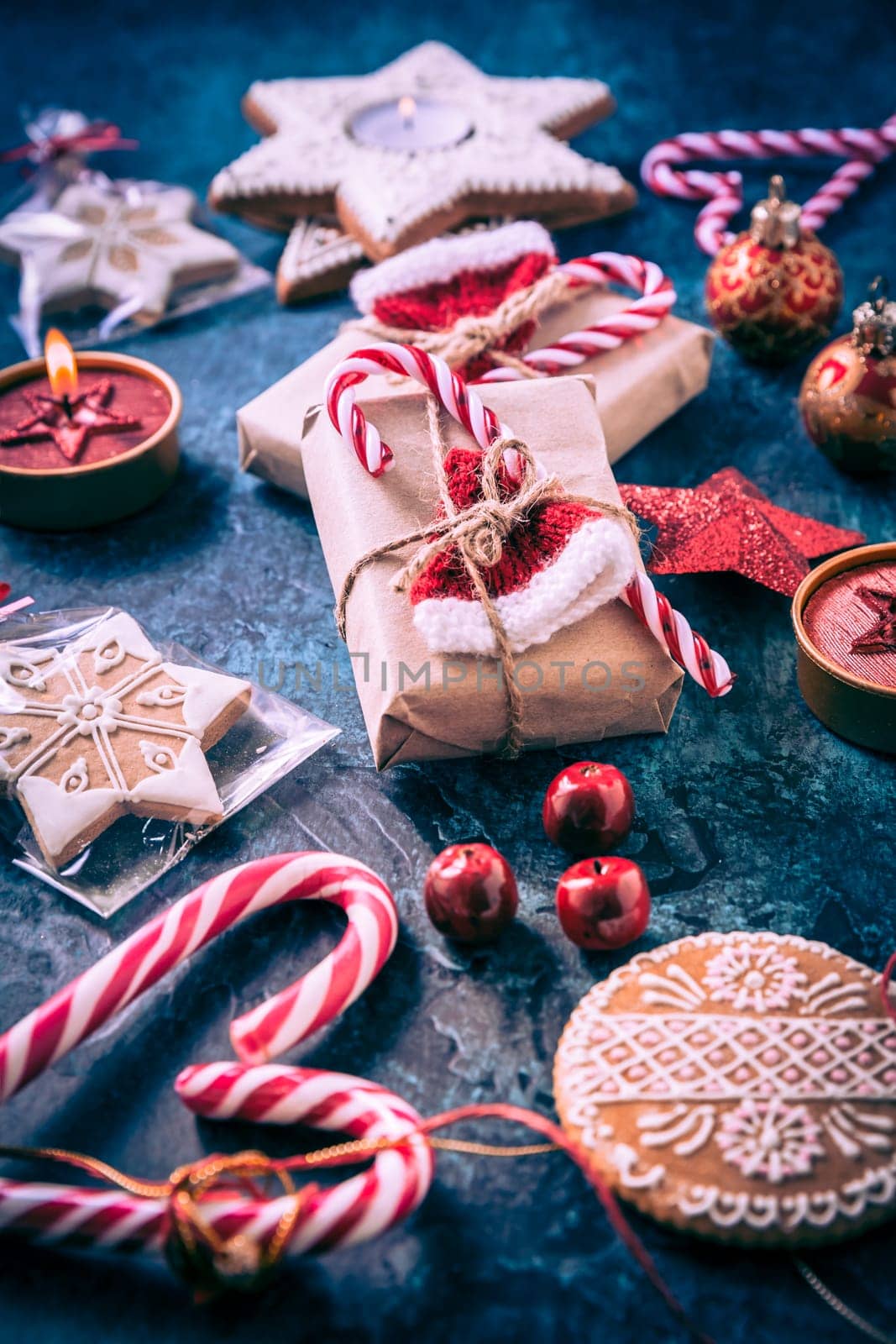 Holiday Christmas Gifts with Boxes, Candle and gingerbread cookies on dark blue background