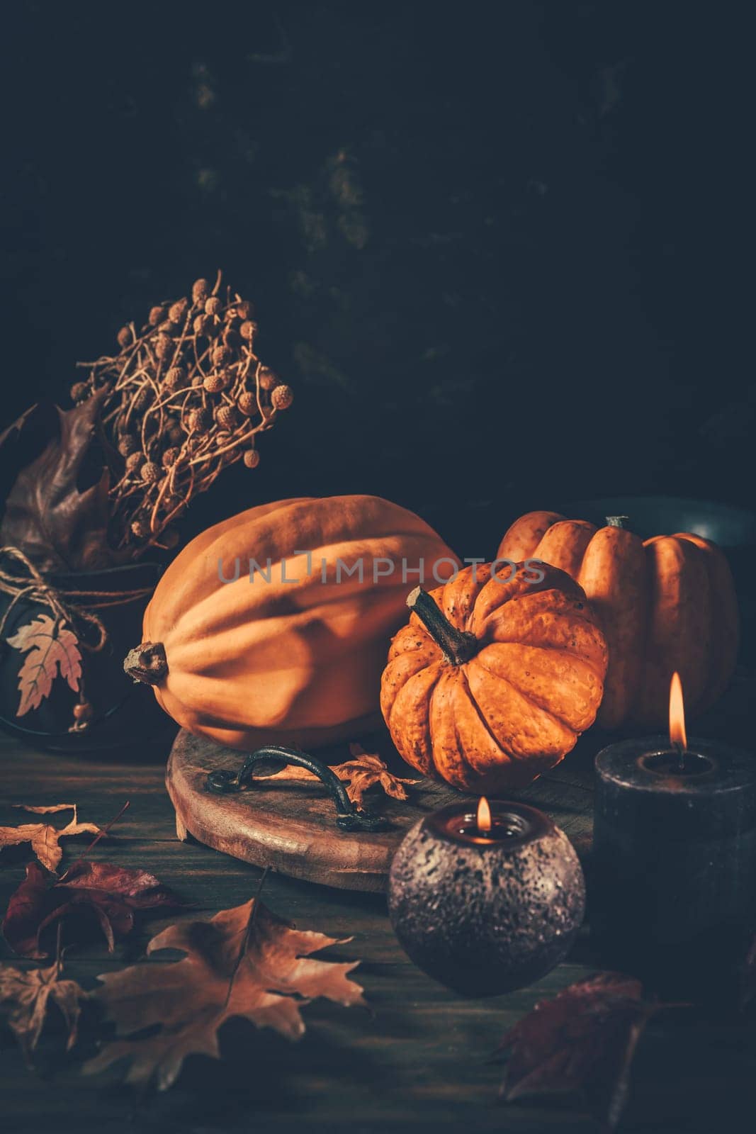 Still life for Thanksgiving with pumpkins and autumn leaves on wooden background