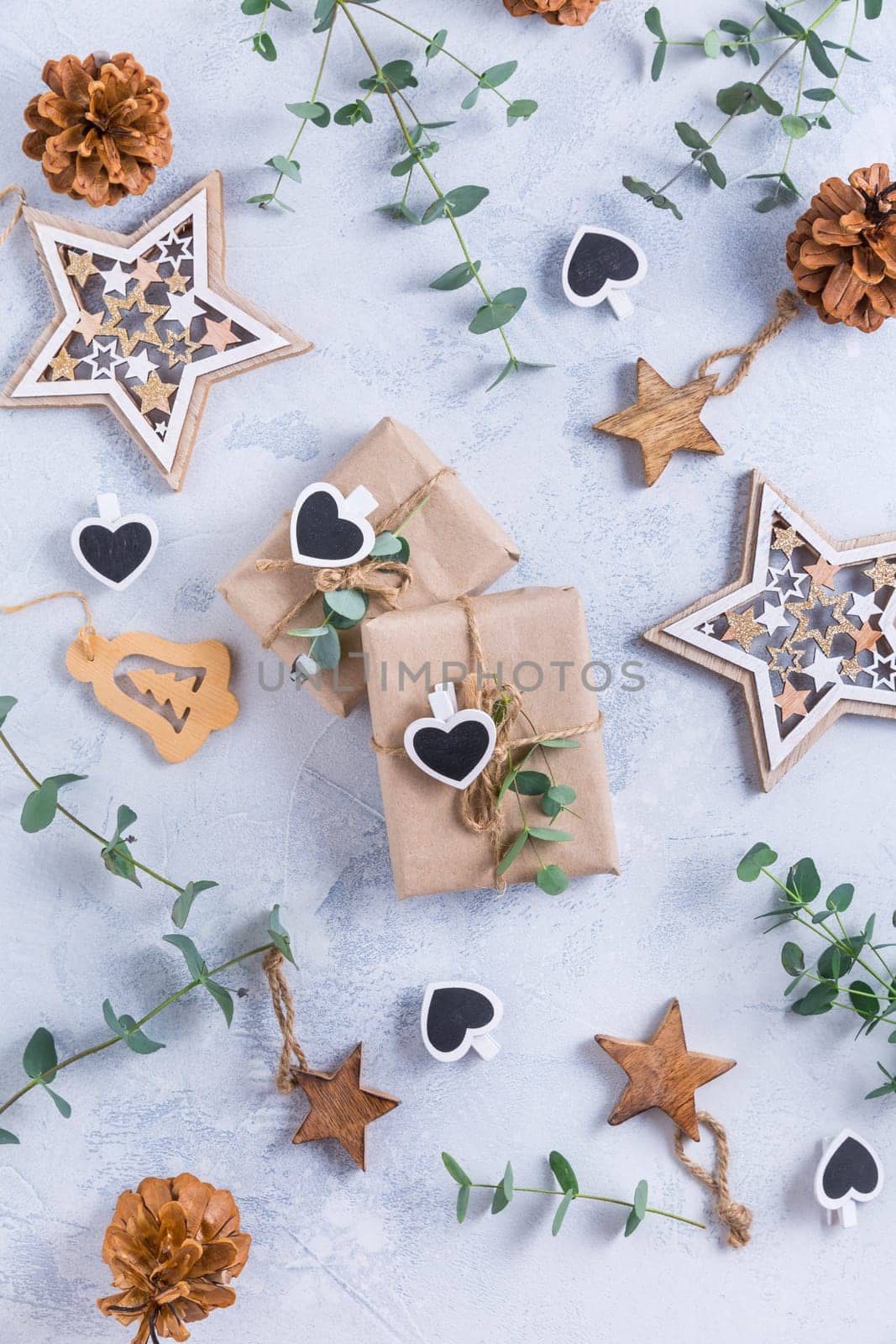 Holiday Christmas Gifts with Boxes, Coniferous, eucalyptus and ornaments on snowy background