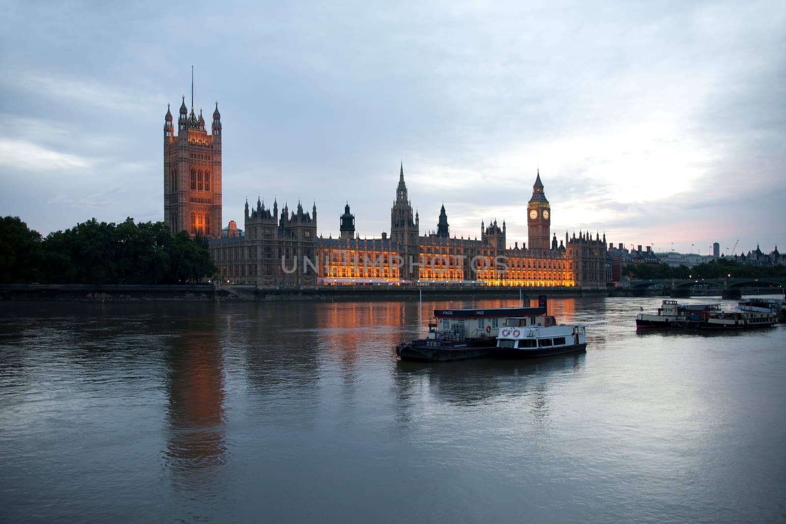 The River Thames boats and Parliament at dusk