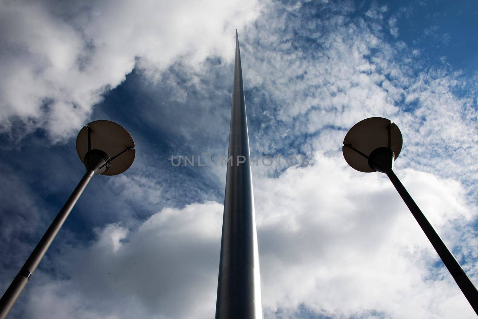 The Spire of Dublin with converging street lights blue sky and clouds