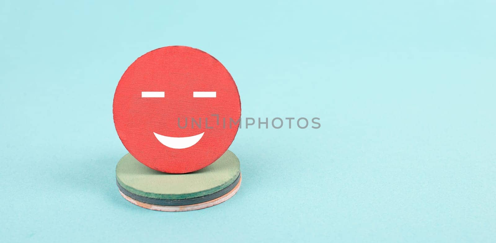 Smiling face, blue colored background, copy space, rating, positive feedback, customer experience, happy emotion
