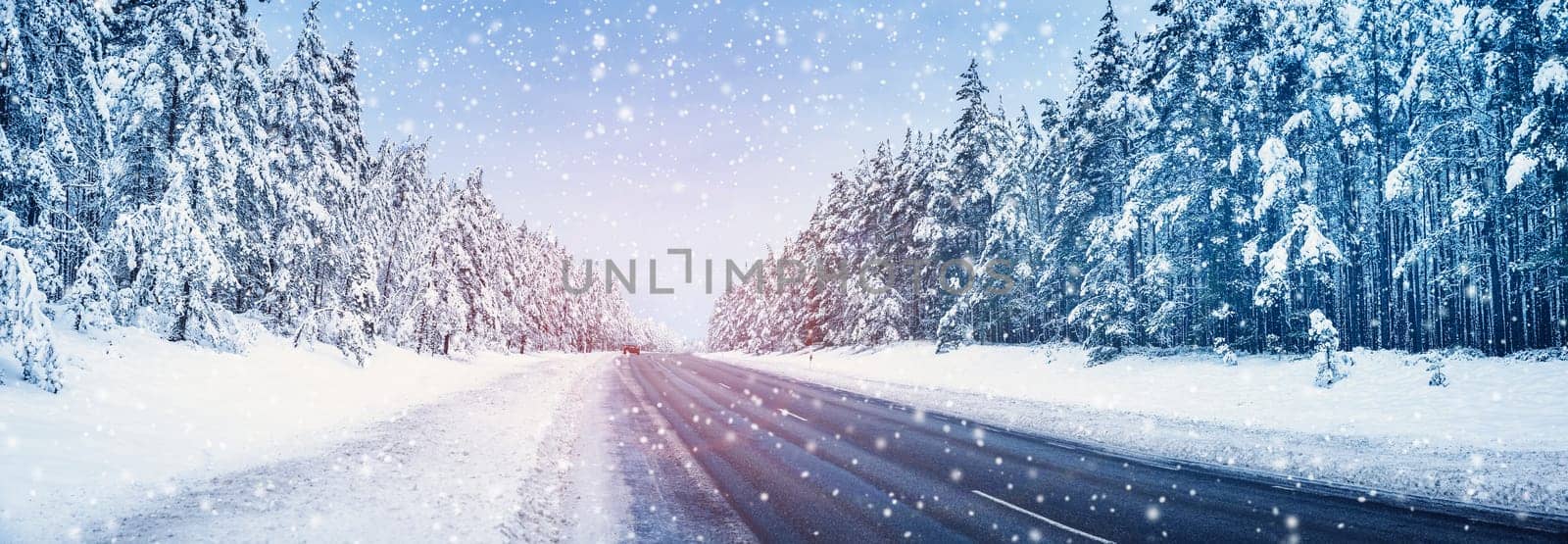 Panoramic view of the beautiful country road in snowfall. Panorama of snowy way in natural park in winter.