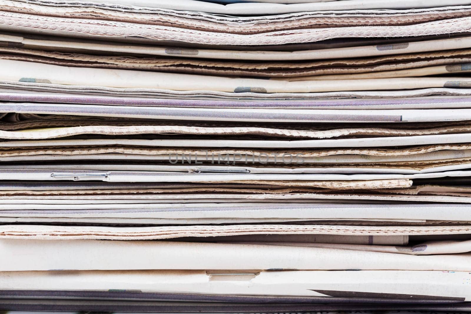 Stack of newspapers closeup shot. News and updates concept.