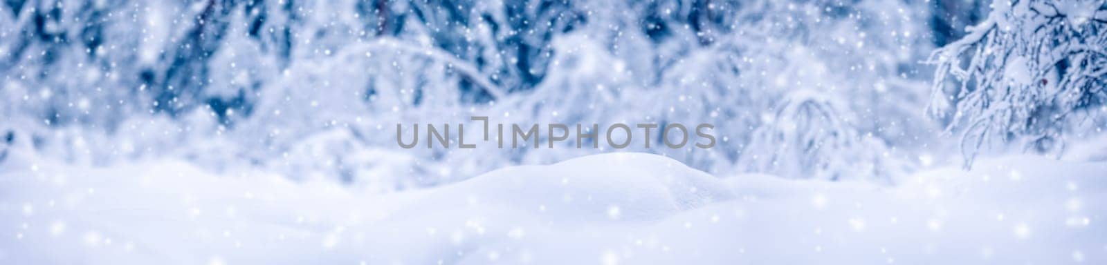 Snowy background with closeup view of the wavy snowdrifts in snowfall. Concept of the wallpaper, background and backdrop.