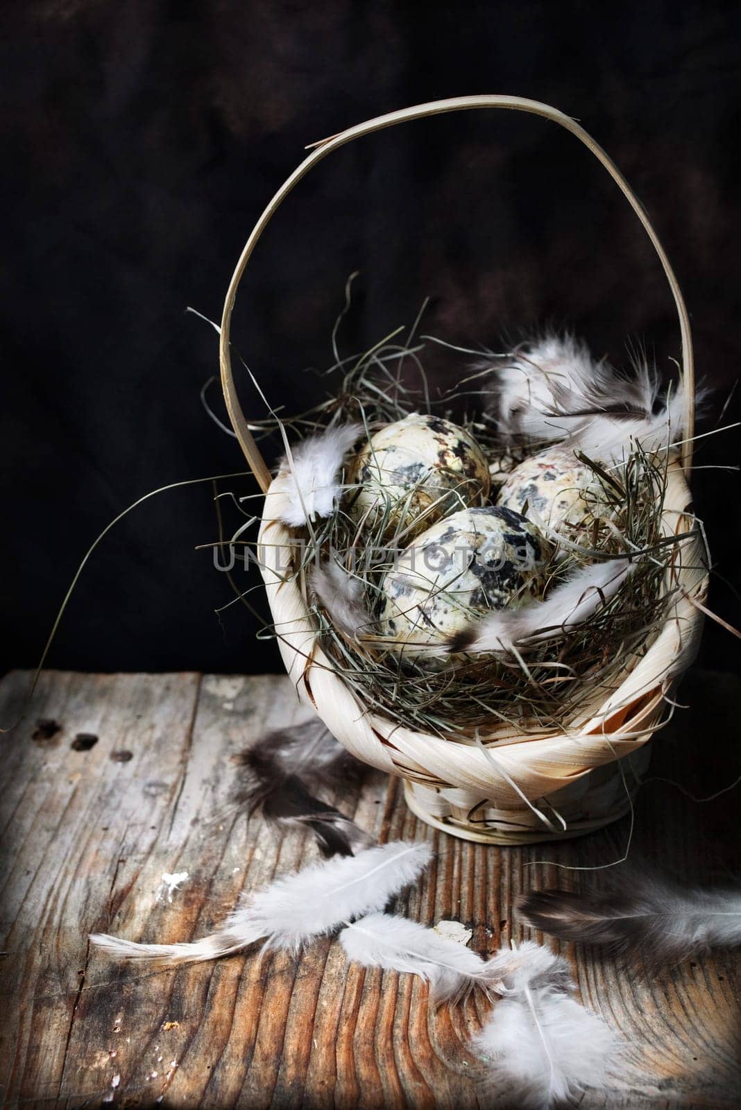 Easter eggs in basket on wooden background