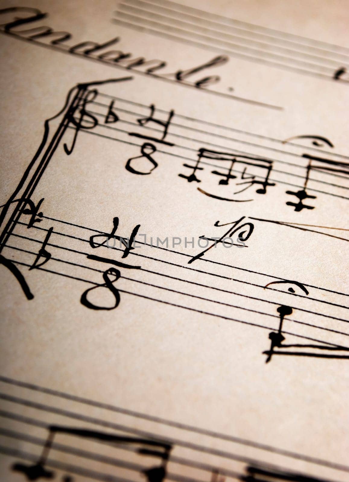 Closeup of handwritten music sheets on an old paper