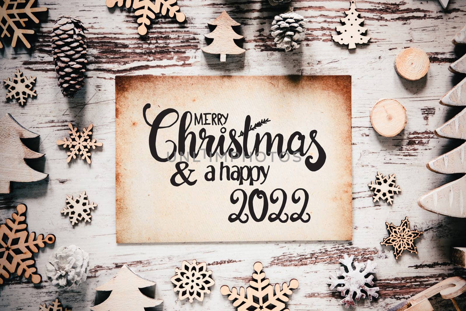 Old Paper With English Calligraphy Merry Christmas And Happy 2022. Vintage White Wooden Christmas Decoration Like Tree