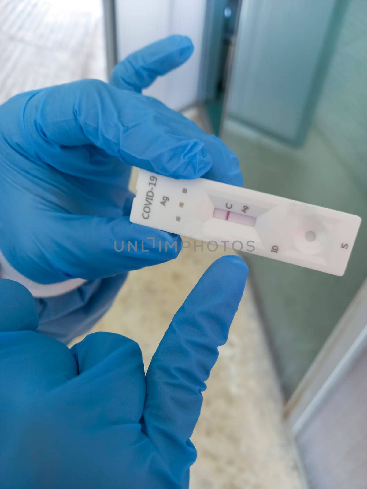 Healthcare worker pointing COVID-19 rapid antigen test. Negative result