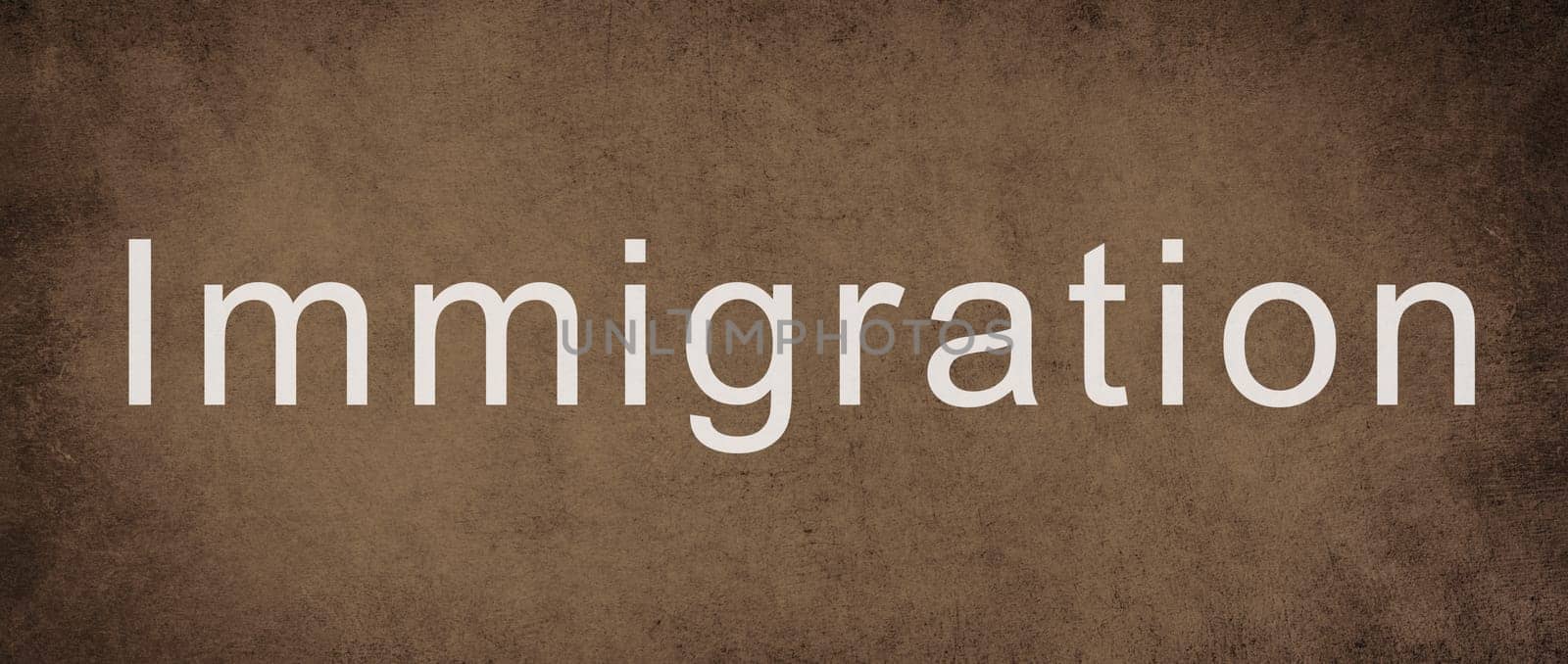 The world immigration is standing on a brown colored wall, refugees Europe, asylem seekers, immigrant