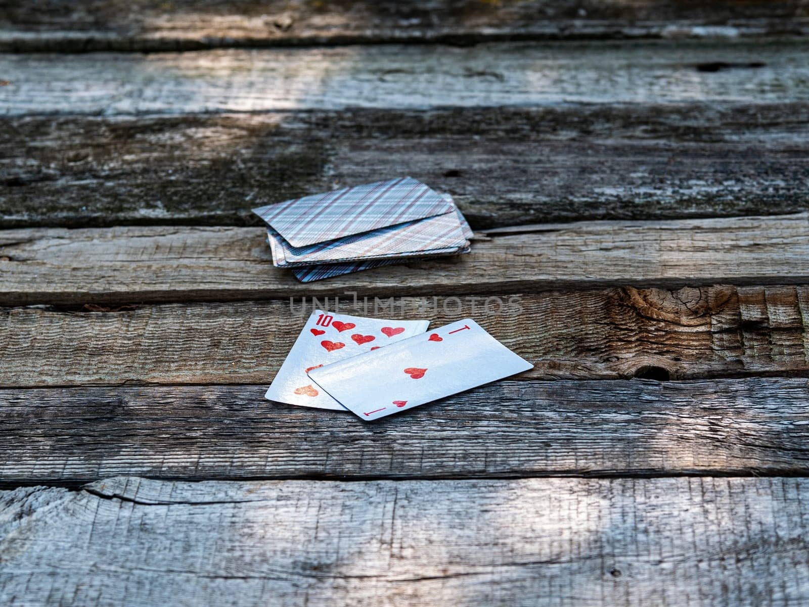 Playing cards ace and ten on a wooden table. A deck of playing cards. Twenty-one points. Gambling. Card suit. Gambling business. Wooden table. Background image.