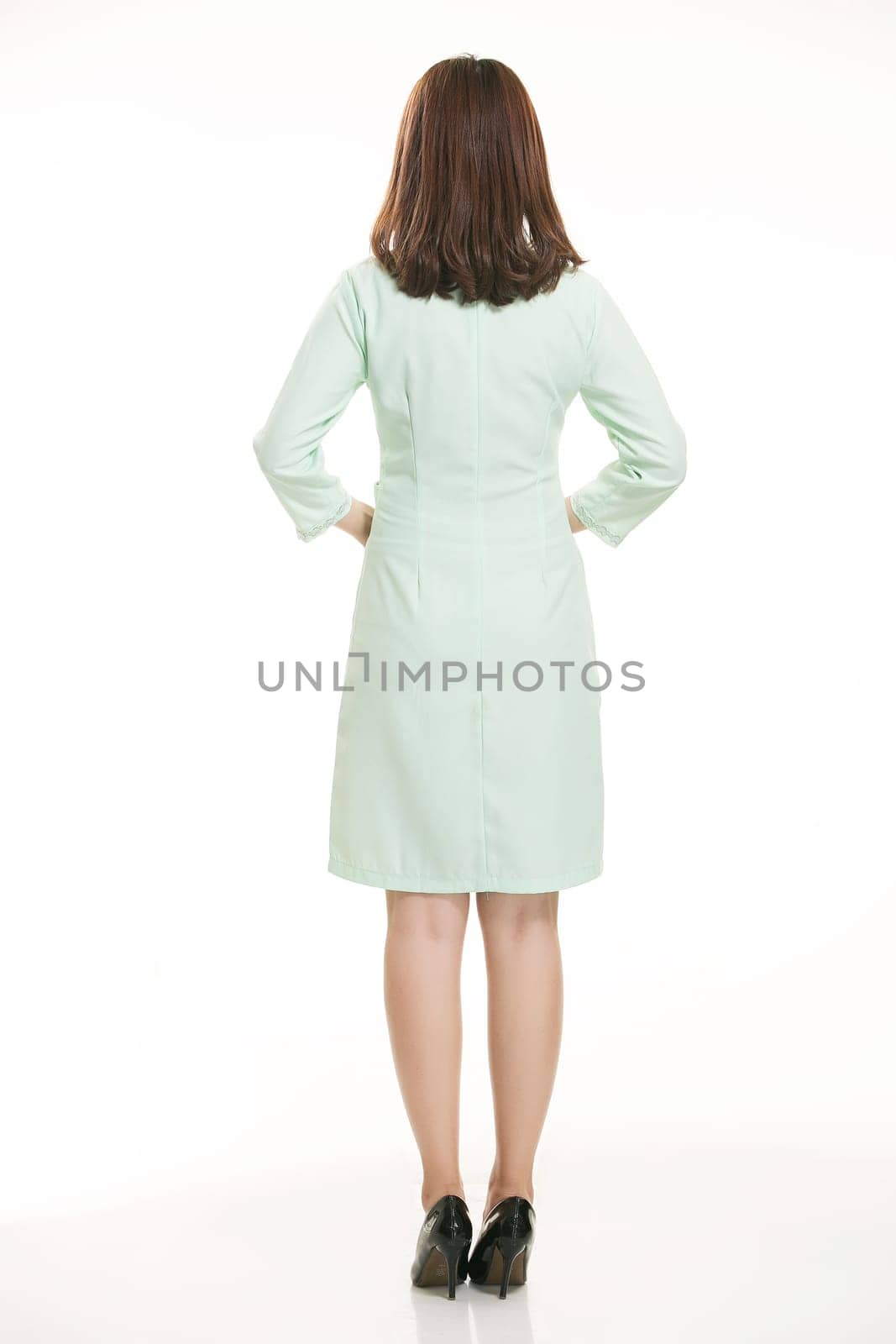 Staff wear coats in front of white background