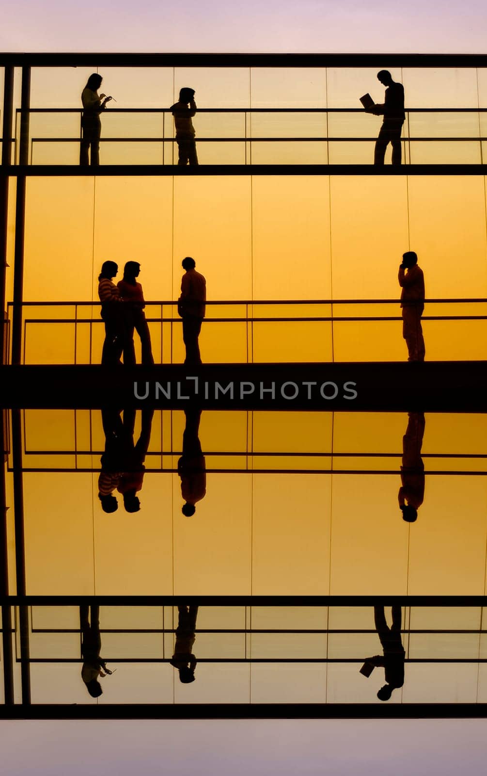 workers inside the office building silhouette at sunset