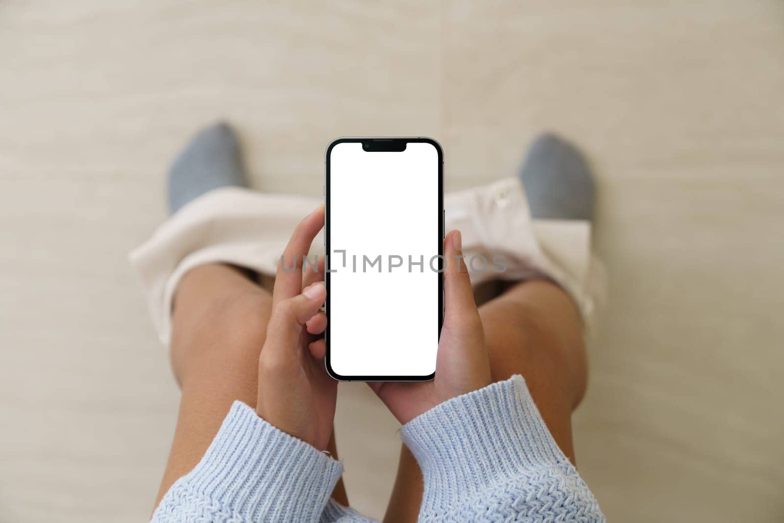 Woman holding a phone while using the toilet, Mock up phone  white screen display in hand